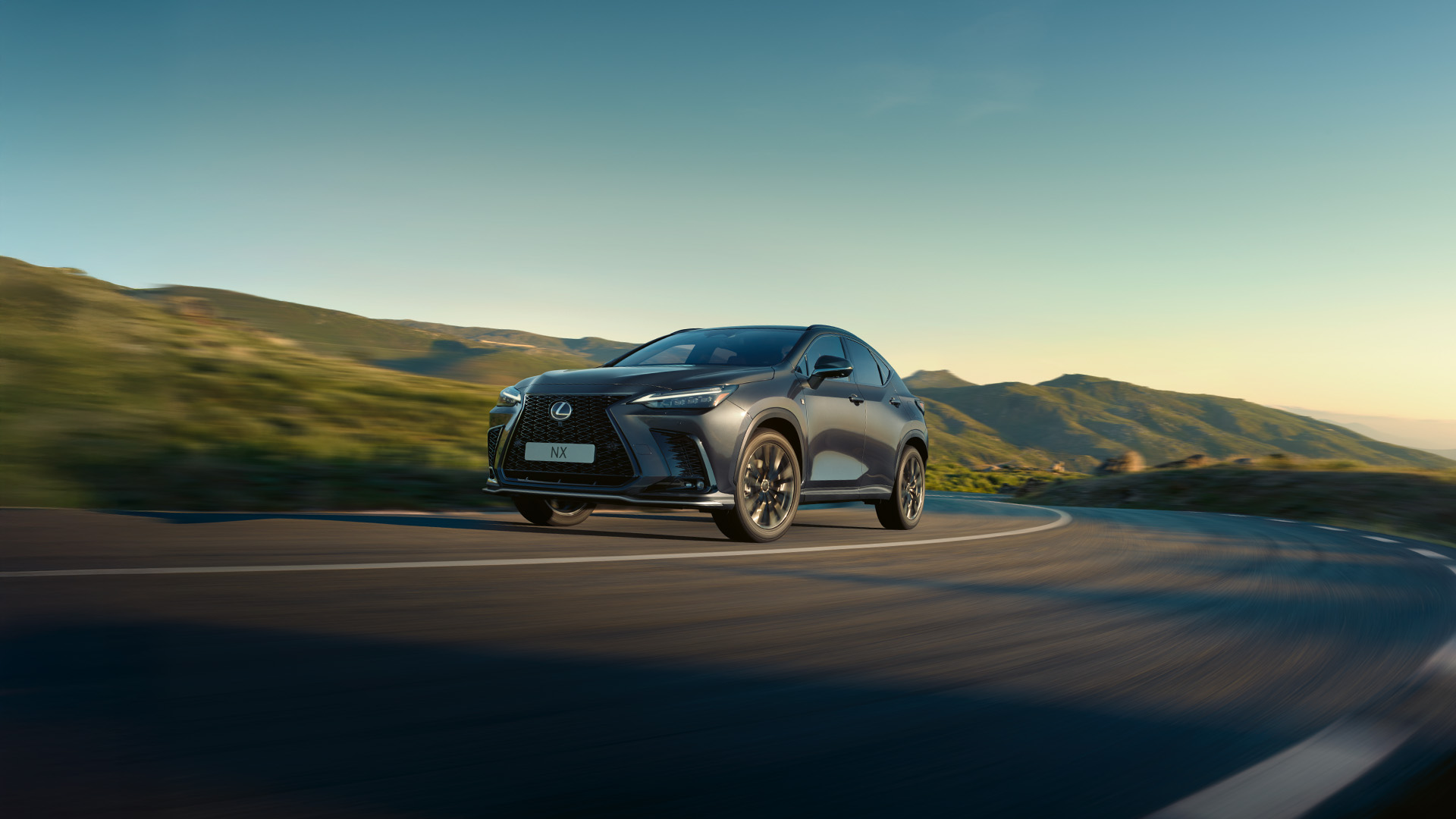 Rear view of a Lexus NX driving on a coastal road